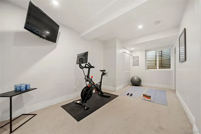 a room with gym equipment and a flat screen tv