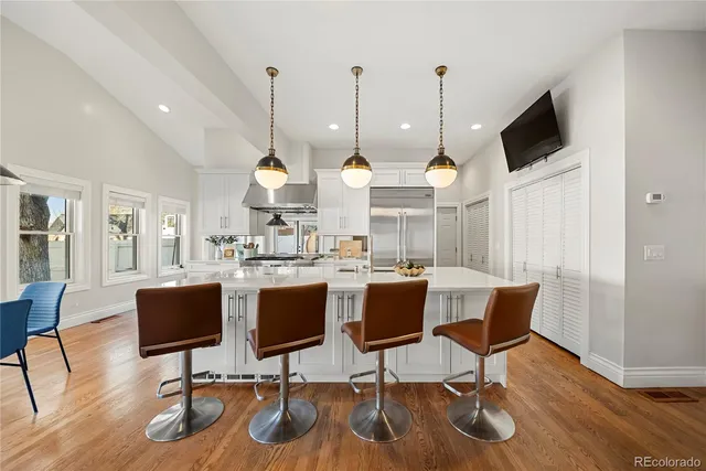 a view of a dining room with furniture wooden floor and chandelier