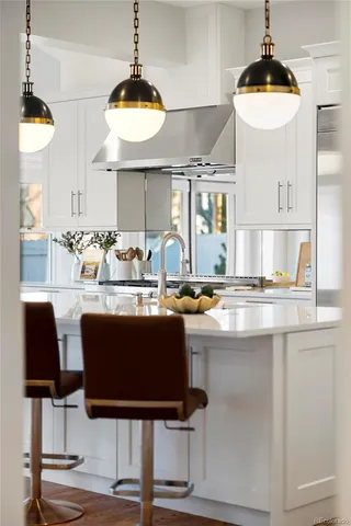 a kitchen with a table and chandelier