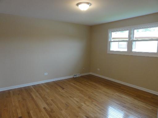 625 Wolf Road Matteson, IL 60443 - Photo 11 of 15 an empty room with wooden floor and windows