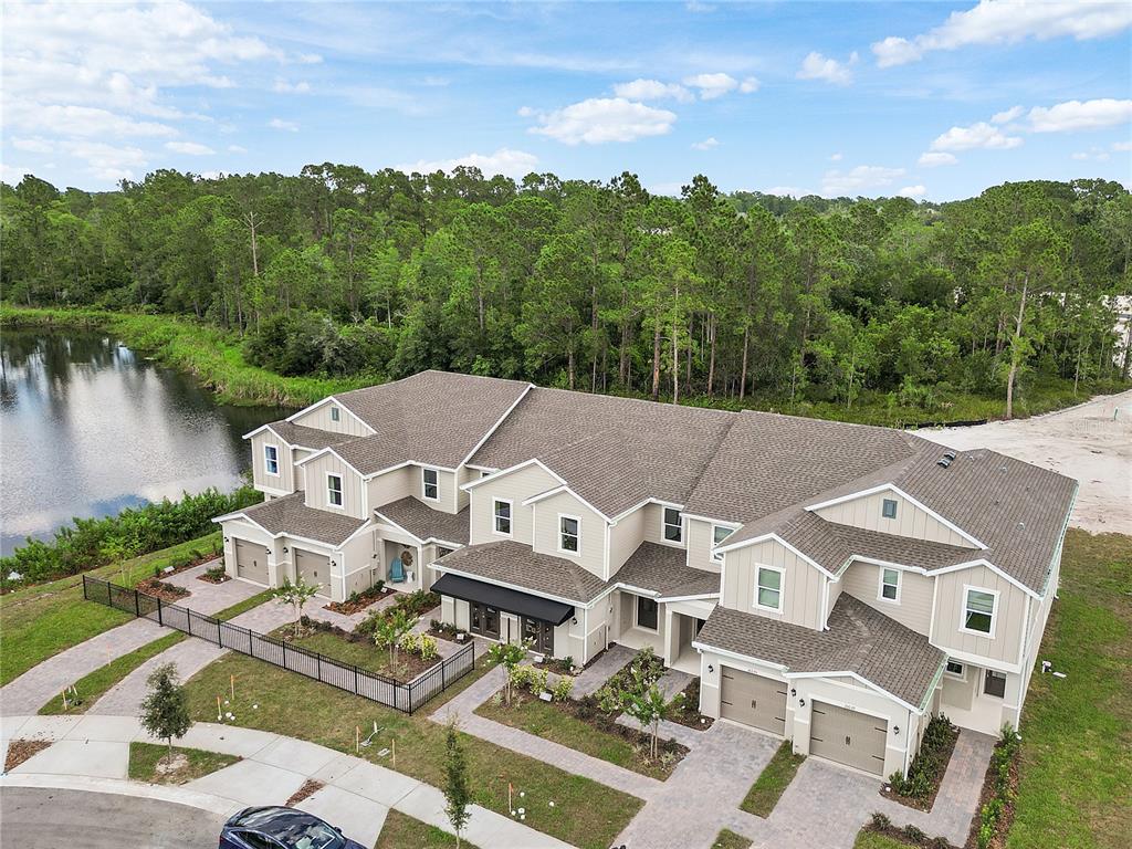 an aerial view of a house with a garden and lake view