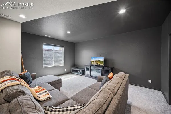 a bedroom with a bed and a lamp