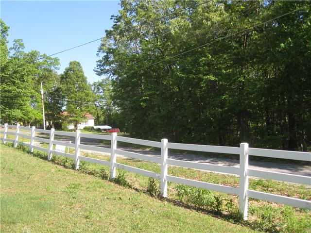 950 Woodhaven Road Lyles, TN 37098 - Photo 16 of 20 Decorative fencing in front, the side is lined with trees and the rear of the property is also fenced.