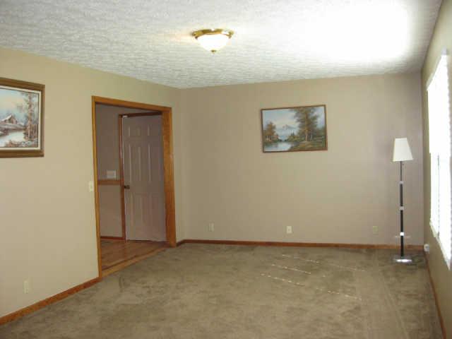 950 Woodhaven Road Lyles, TN 37098 - Photo 3 of 20 Enter front door into spacious living room (12x21), neutral carpet (2010), doorway on left opens to dining room and door to attached garage just inside. Nice big windows look out to lovely front views.