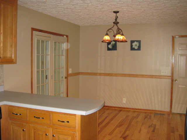 950 Woodhaven Road Lyles, TN 37098 - Photo 4 of 20 11x12 dining room with beautiful hardwood floors(2010) and double French doors that take you to the Florida room and back entrance of the home.