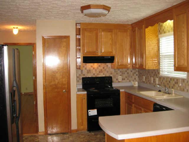 950 Woodhaven Road Lyles, TN 37098 - Photo 5 of 20 Good sized kitchen includes 2 pantries, 25 cubic foot Stainless steel refrigerator, dishwasher and brand new stove.