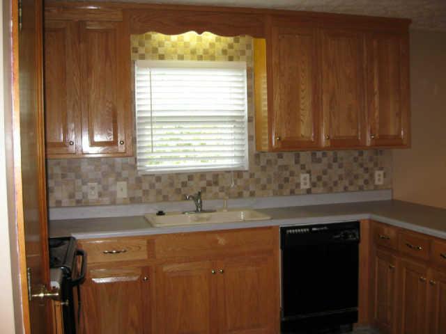 950 Woodhaven Road Lyles, TN 37098 - Photo 6 of 20 Solid oak cabinets with raised panel doors and hidden hinges, lots of counter space and snack bar. Ceramic tile backsplash.