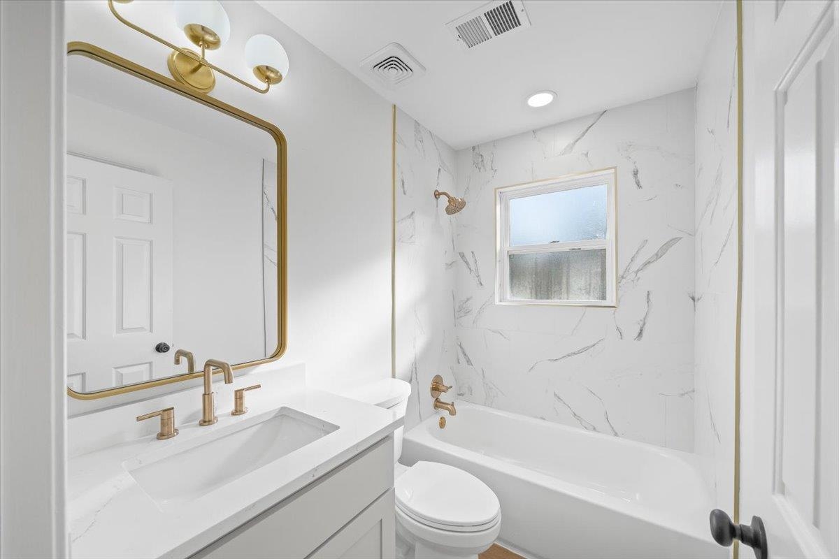 1676 Miller Farms Road Germantown, TN 38138 - Photo 22 of 37 Contemporary bathroom featuring a white vanity with integrated sink and brushed gold fixtures