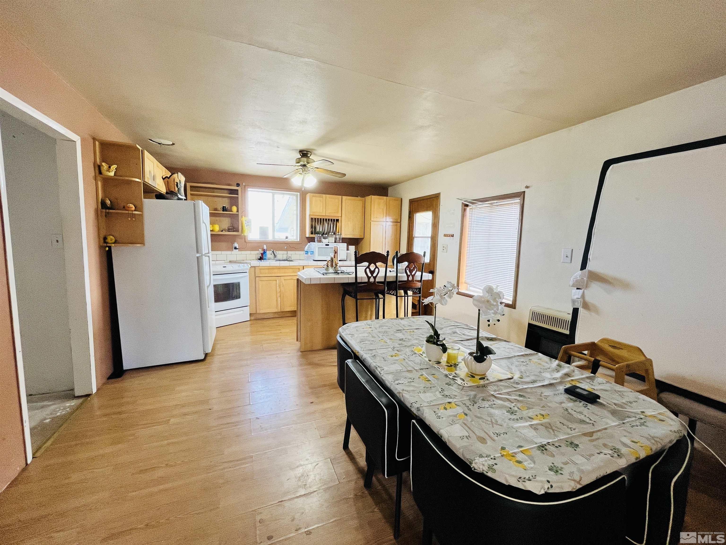 249 Us Highway 95a North Yerington, NV 89447 - Photo 4 of 24 a kitchen with refrigerator and chairs
