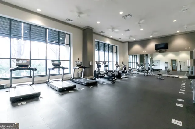 a room with gym equipment and a large window