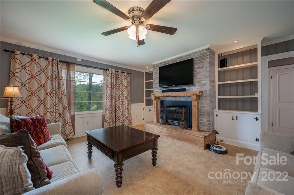 488 Elliott Road Rutherfordton, NC 28139 - Photo 12 of 44 a living room with furniture a fireplace and a flat screen tv