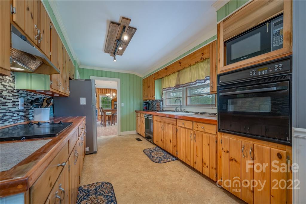 488 Elliott Road Rutherfordton, NC 28139 - Photo 13 of 44 a kitchen with stainless steel appliances granite countertop a stove a sink and a microwave