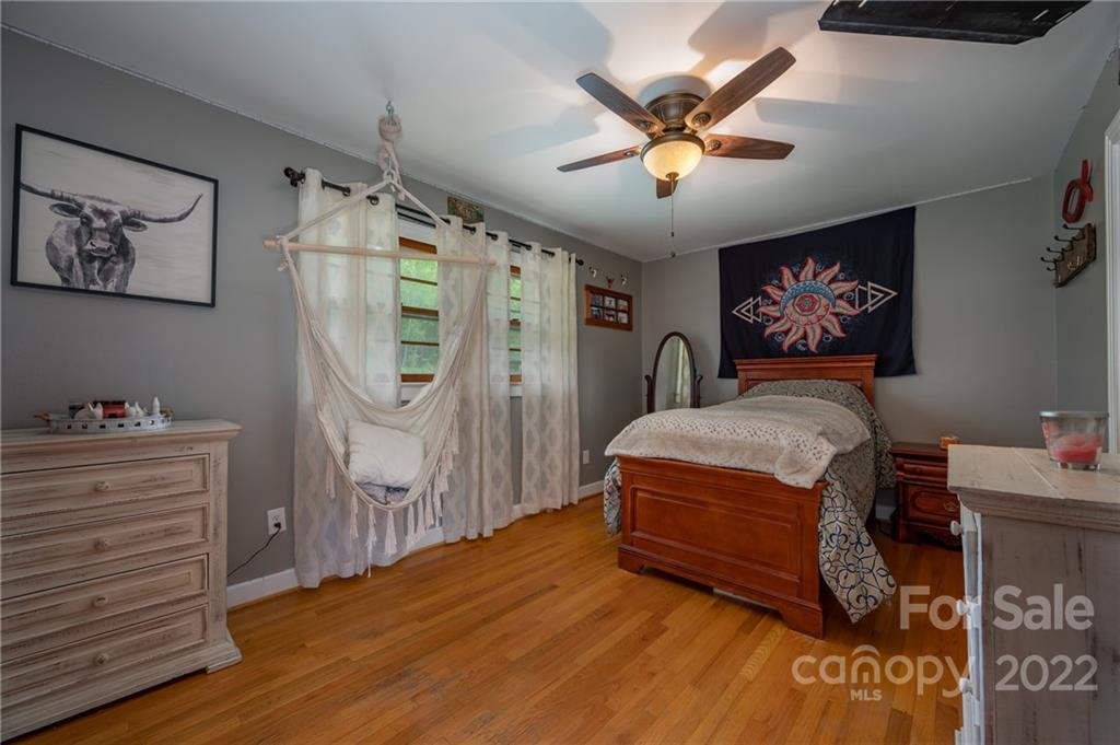 488 Elliott Road Rutherfordton, NC 28139 - Photo 19 of 44 a bedroom with a bed and a chandelier