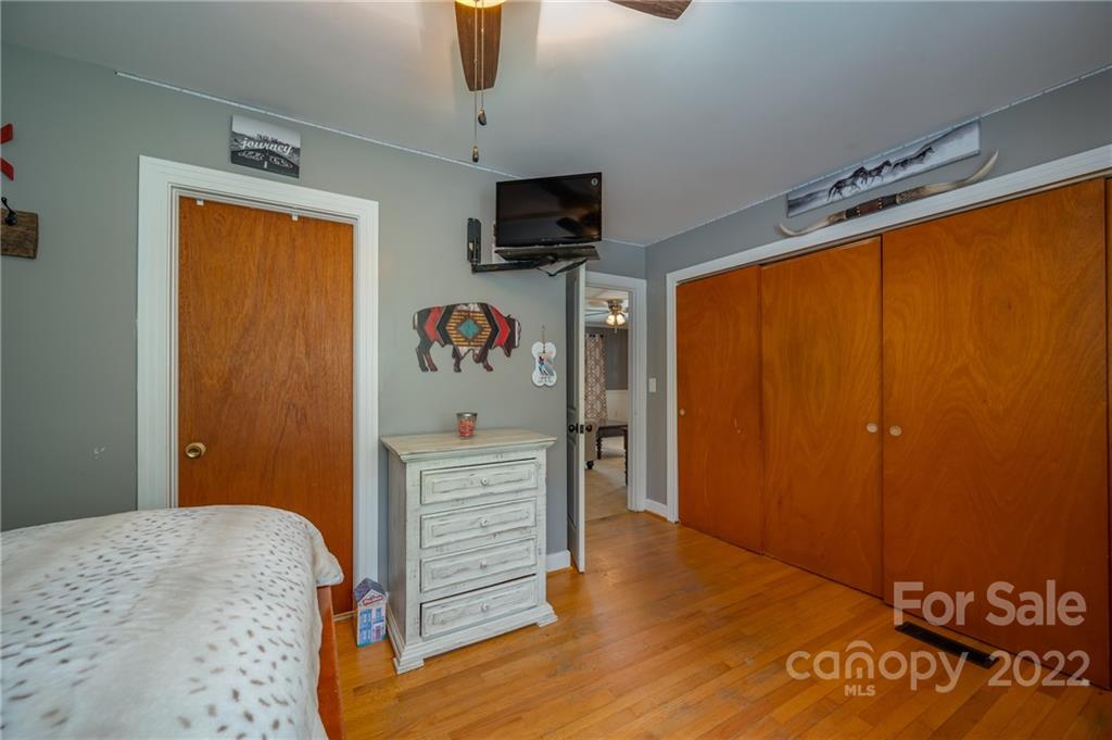 488 Elliott Road Rutherfordton, NC 28139 - Photo 20 of 44 a bedroom with a bed and wooden floor