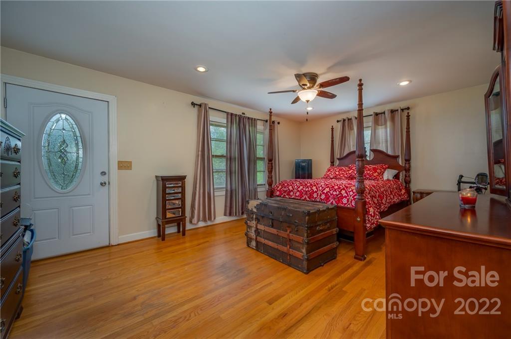 488 Elliott Road Rutherfordton, NC 28139 - Photo 21 of 44 a living room with furniture a clock and a flat screen tv