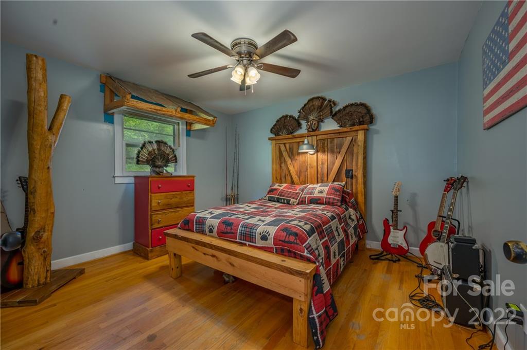 488 Elliott Road Rutherfordton, NC 28139 - Photo 23 of 44 a bedroom with a bed and wooden floor