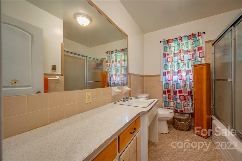 488 Elliott Road Rutherfordton, NC 28139 - Photo 25 of 44 a bathroom with a sink a toilet and shower curtain