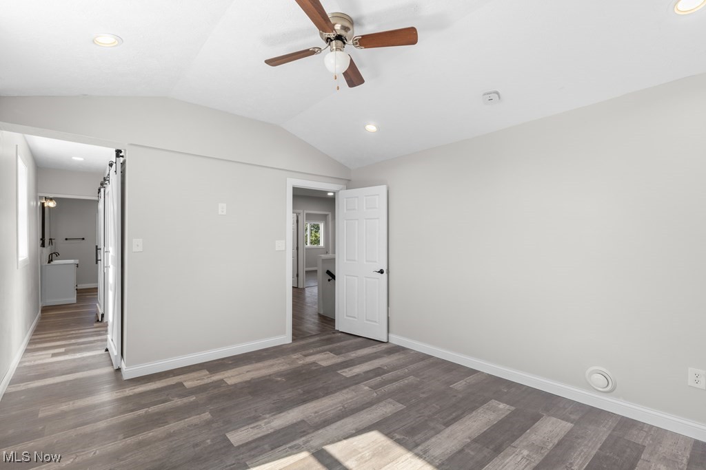 139 Patterson Road Weirton, WV 26062 - Photo 24 of 46 Unfurnished bedroom with lofted ceiling, wood finished floors, ceiling fan, recessed lighting, and a barn door