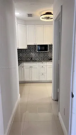 a bathroom with a granite countertop sink a vanity and a mirror