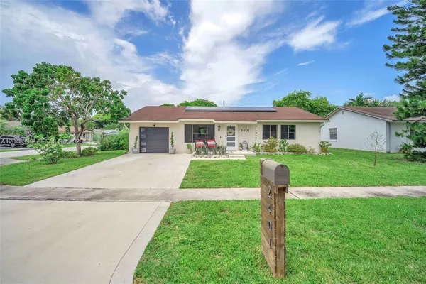 a view of house that has a yard