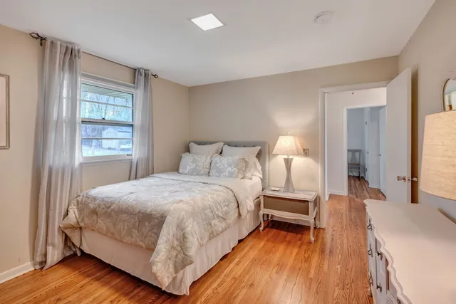 a spacious bedroom with a bed and a window