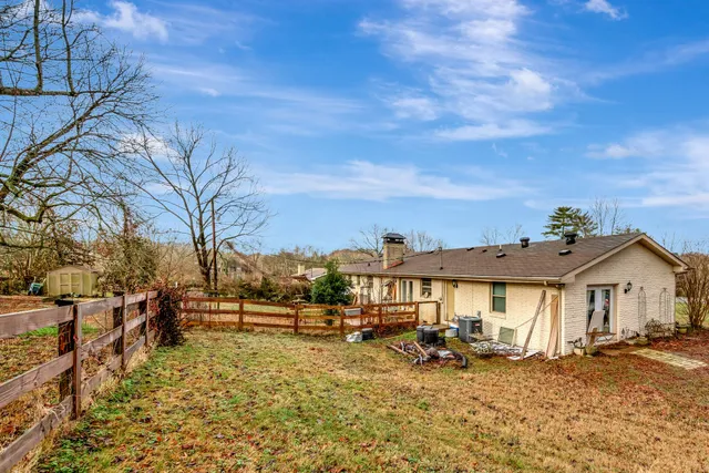 a view of a house with yard and sitting area