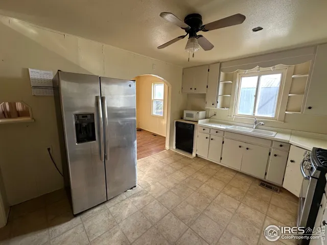 a kitchen with stainless steel appliances a refrigerator sink and stove