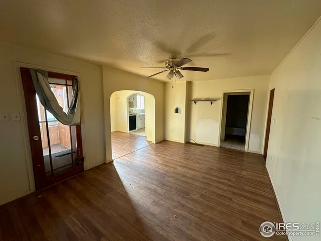 a view of a hallway with wooden floor and cabinet with a fireplace