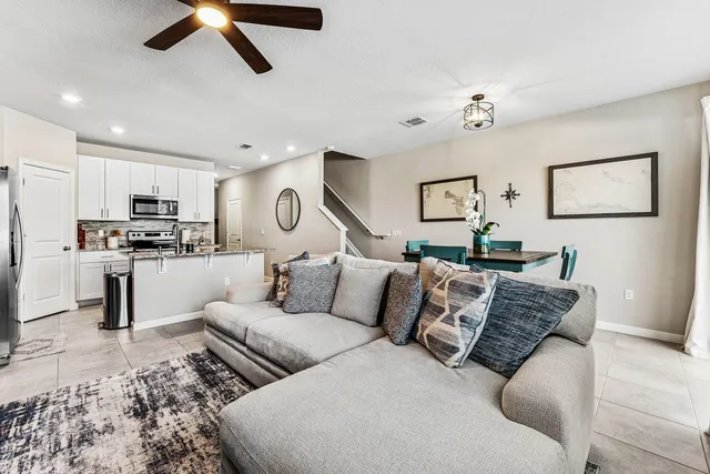 a living room with furniture and kitchen view