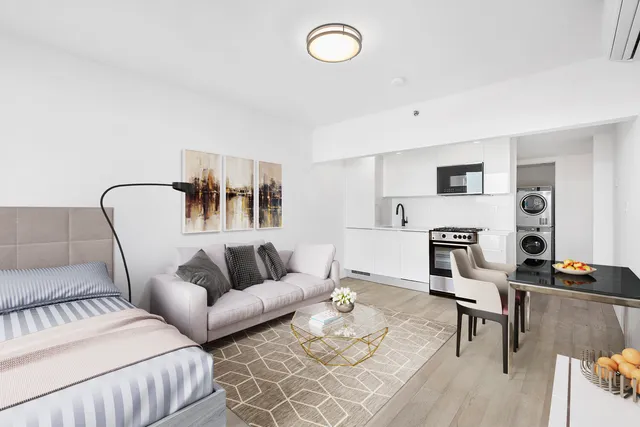 a living room with furniture and a dining table