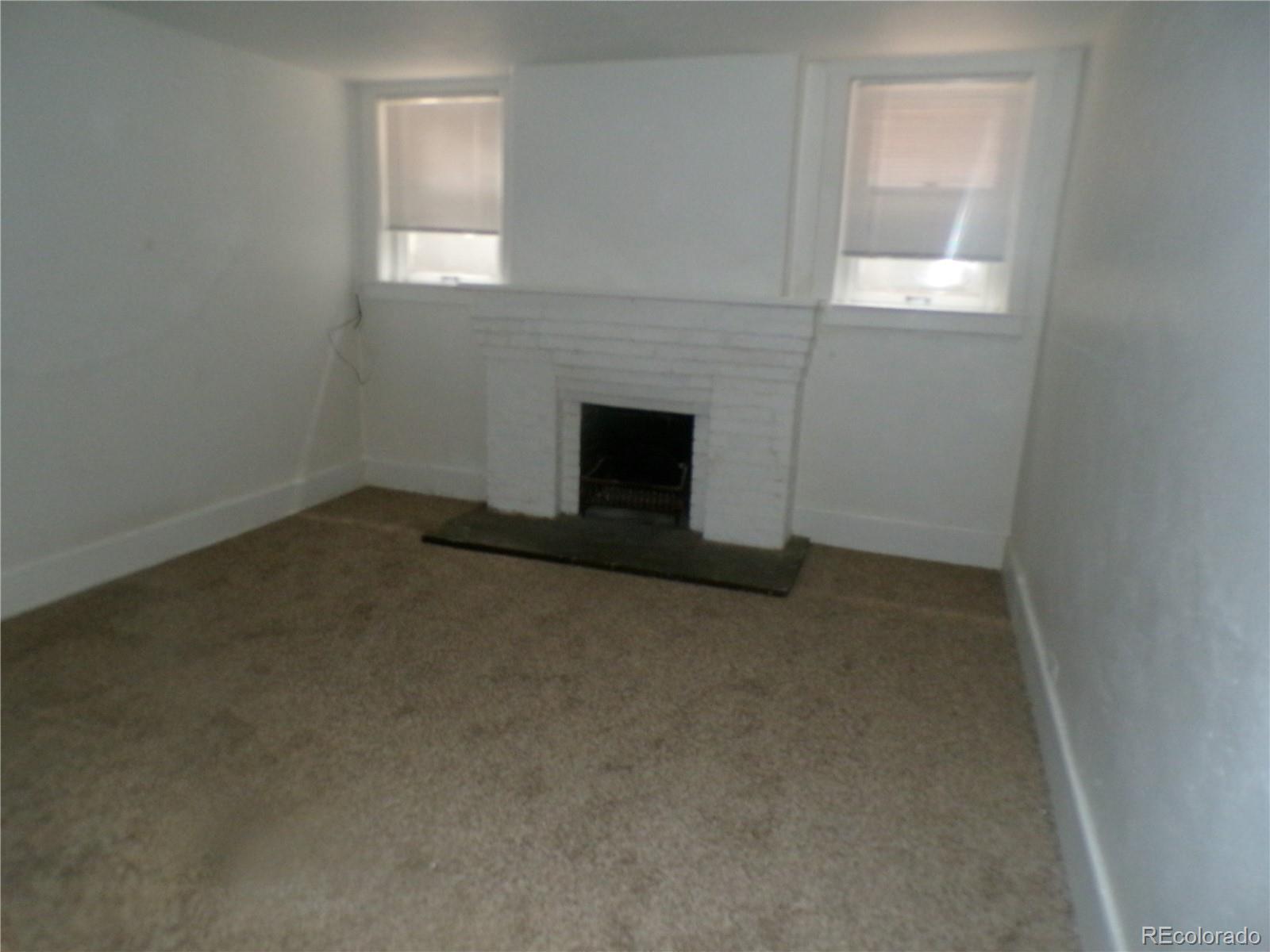 644 North Marion Street Denver, CO 80218 - Photo 2 of 19 an empty room with a fireplace