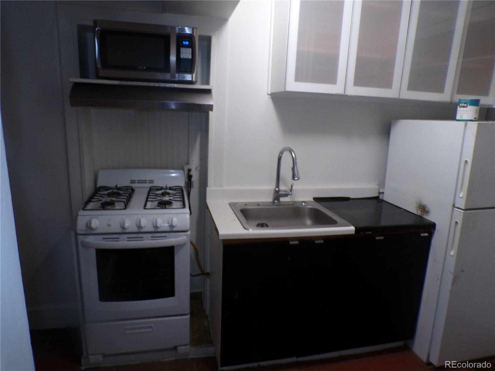 644 North Marion Street Denver, CO 80218 - Photo 10 of 19 a kitchen with stainless steel appliances granite countertop a sink stove and refrigerator