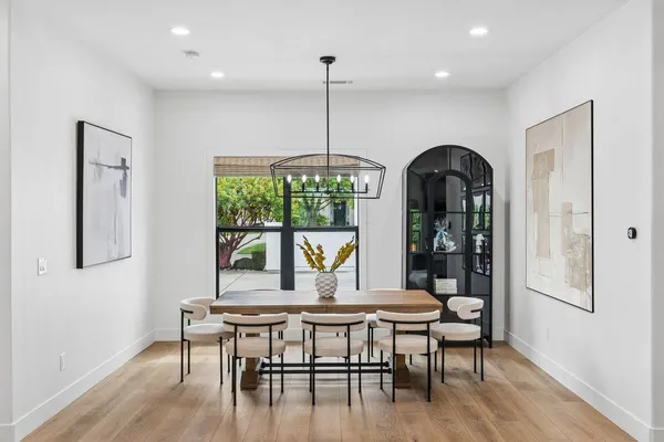 a kitchen with stainless steel appliances granite countertop a kitchen island a stove a table and chairs