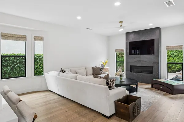 a dining room with furniture and a floor to ceiling window