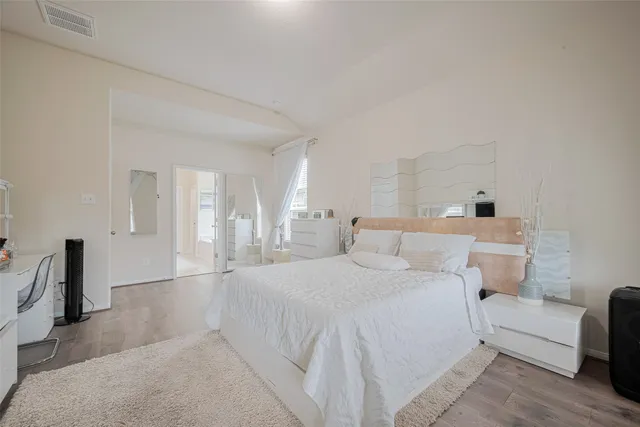 a bathroom with a tub a sink and a large mirror