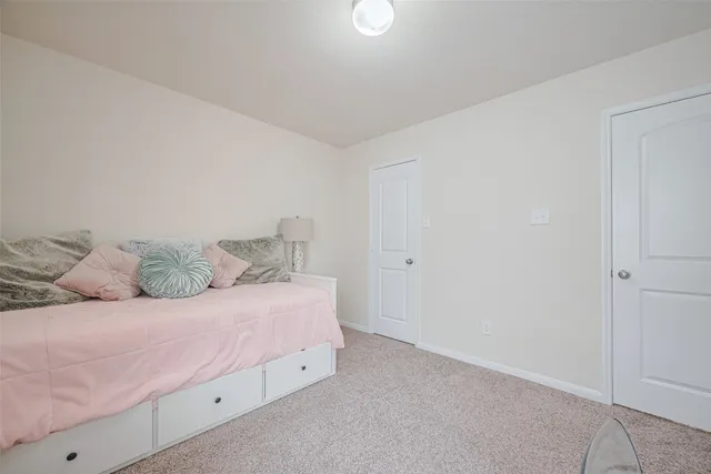 a bathroom with a double vanity sink toilet and a mirror