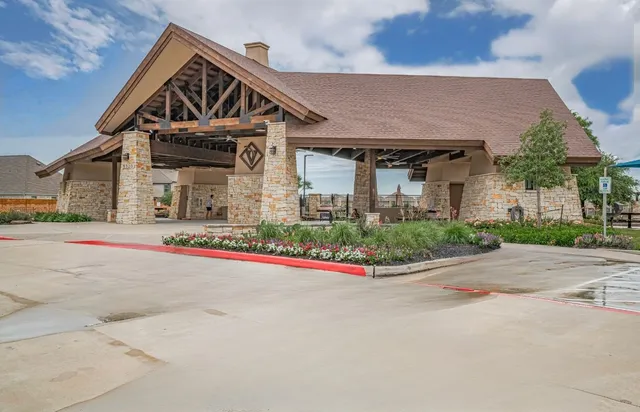 a front view of a house with a garden and plants