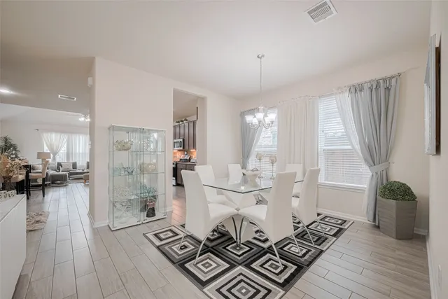 a view of a dining room with furniture window and wooden floor