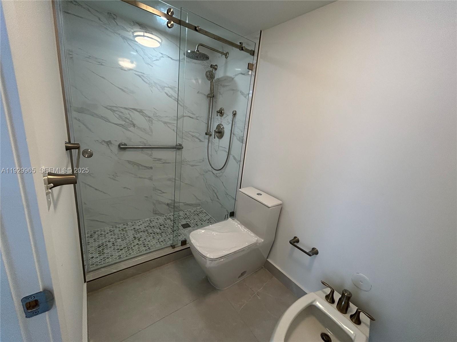 177 Ocean Ln Drive, Unit 715 Key Biscayne, FL 33149 - Photo 12 of 24 a bathroom with a toilet and a shower