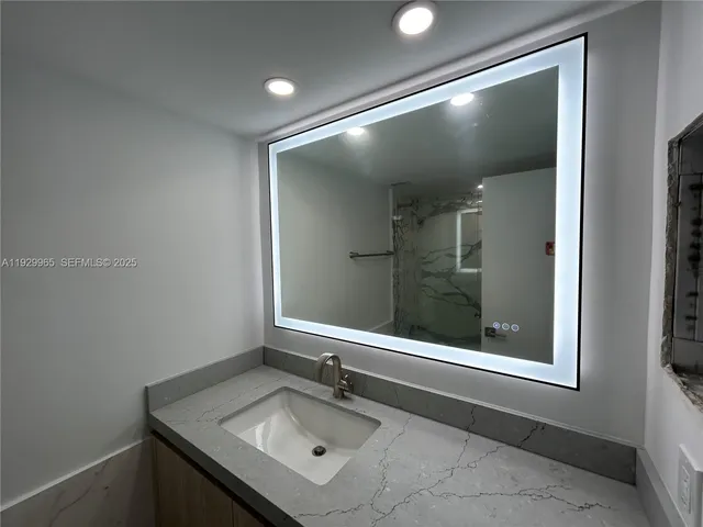 a bathroom with a sink and mirror