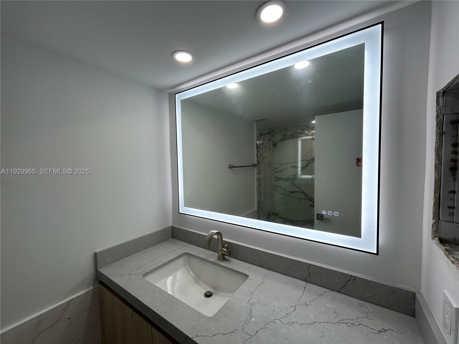 177 Ocean Ln Drive, Unit 715 Key Biscayne, FL 33149 - Photo 19 of 24 a bathroom with a sink and mirror