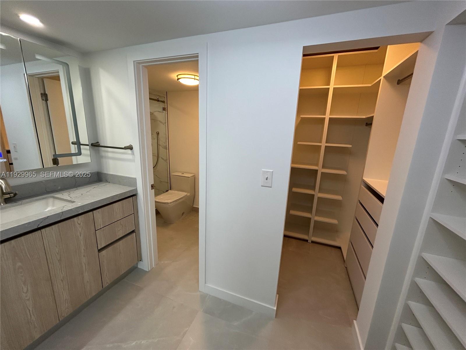 177 Ocean Ln Drive, Unit 715 Key Biscayne, FL 33149 - Photo 9 of 24 a bathroom with a granite countertop sink and a mirror