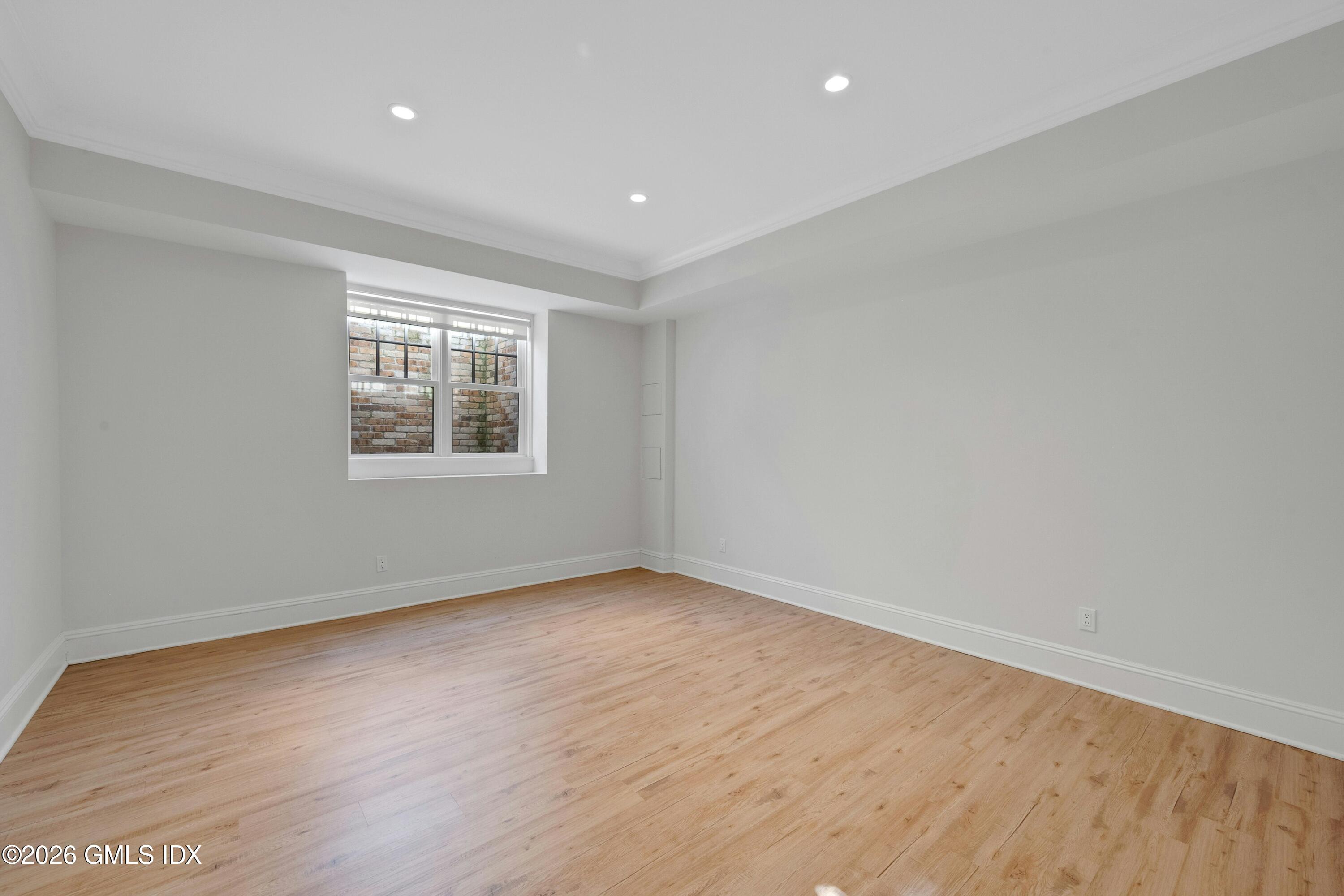 17 Pintail Lane Greenwich, CT 06830 - Photo 26 of 31 an empty room with wooden floor and windows