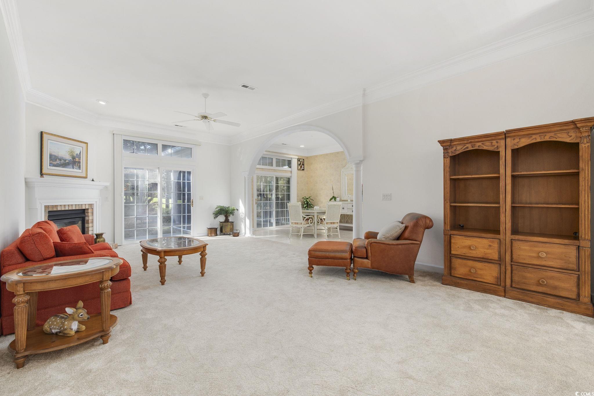 4567 Carriage Run Circle Murrells Inlet, SC 29576 - Photo 7 of 40 Carpeted living room with ornate columns, crown mo