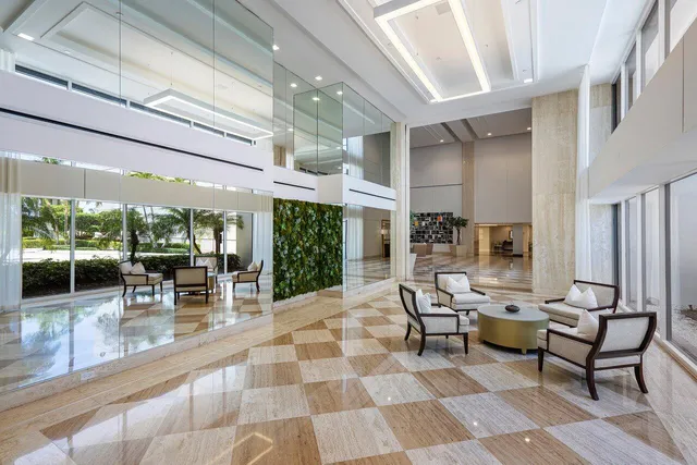 a living room with patio furniture and a chandelier