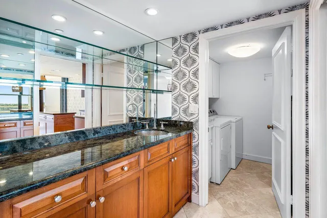 a view of a sink and a refrigerator in a room