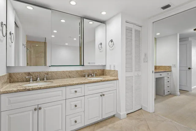 a bathroom with a granite countertop sink mirror and double
