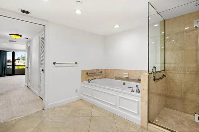 a bathroom with a bathtub and a shower