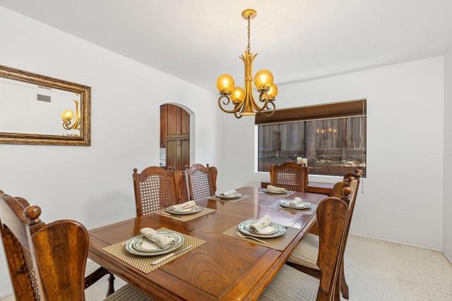 a view of a dining room with furniture wooden floor and chandelier