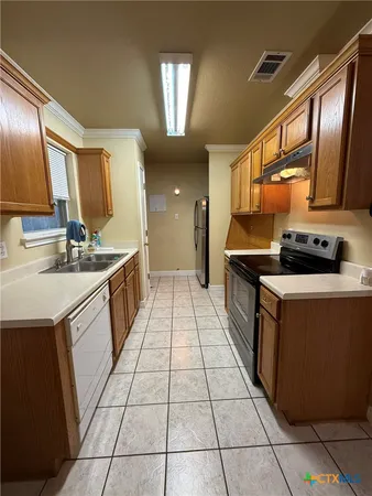 an empty room with a ceiling fan and window